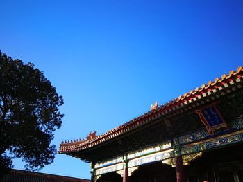 Low angle view of building against clear blue sky