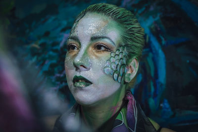 Close-up portrait of young woman looking away