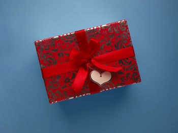 Low angle view of red umbrella against blue sky