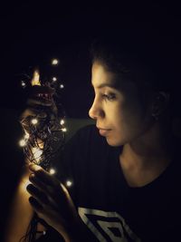 Portrait of young man looking away at night