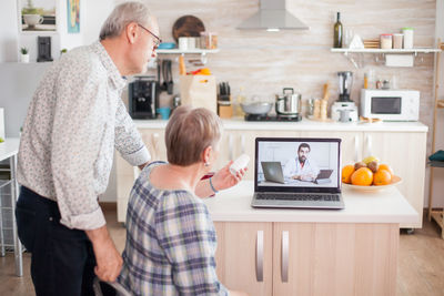 Full length of father and son using smart phone