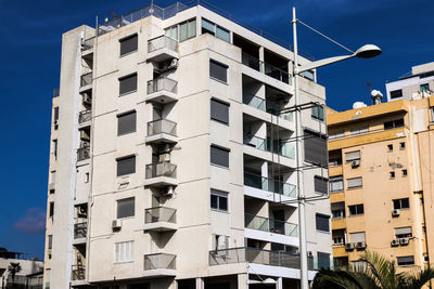 Low angle view of buildings against blue sky