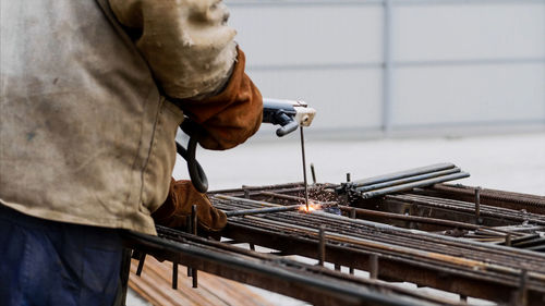 Man working on metal structure in factory