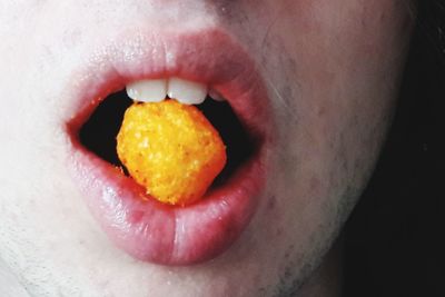 Close-up of man eating fruit