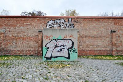 Graffiti on abandoned building against sky