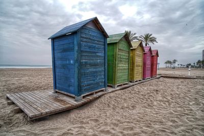 Hut on beach against sky