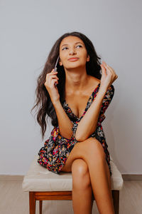 Portrait of beautiful young woman sitting at home