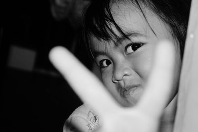 Portrait of cute girl gesturing in darkroom