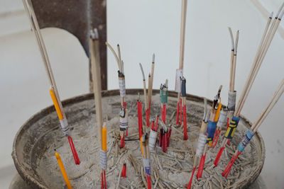 Close-up of paintbrushes in temple against building