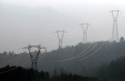 Low angle view of electricity pylon against sky