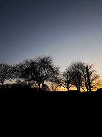 Silhouette trees against sky during sunset