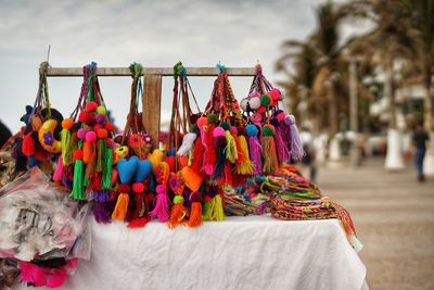 Close-up of multi colored decorations hanging for sale in market