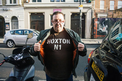 Portrait of smiling man standing in city