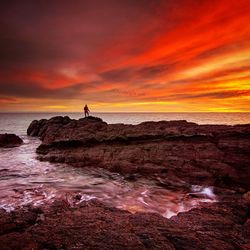 Scenic view of sea against cloudy sky