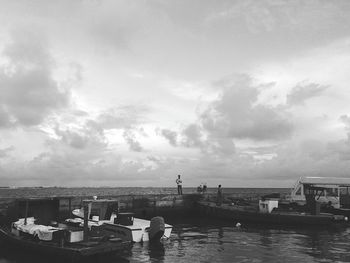 Boats moored in sea against sky