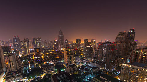 Aerial view of city lit up at night