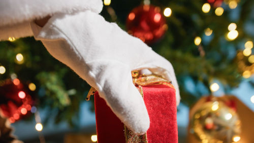 Cropped hand of woman holding christmas decoration