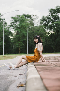 Side view of woman sitting outdoors