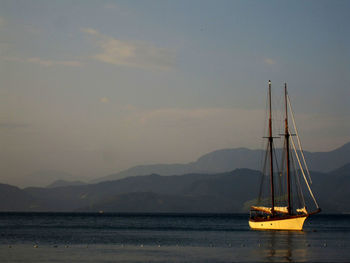 Sailboat sailing on sea against sky