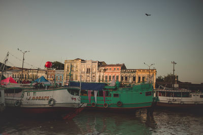 View of boats in river against clear sky