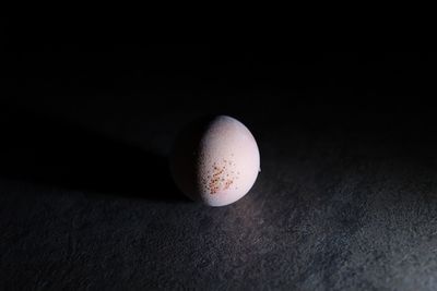 Close-up of ball on table against black background