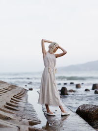 Young woman standing at beach