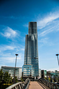 Low angle view of modern buildings against blue sky