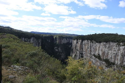 Scenic view of waterfall against sky