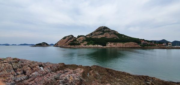 Panoramic view of sea and rocks against sky