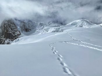 Scenic view of snow covered mountains against sky