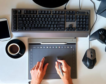 High angle view of person using graphic design on desk workspace 