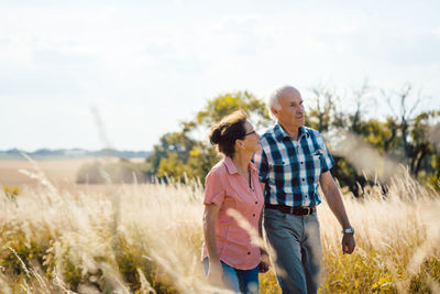 Couple standing on field