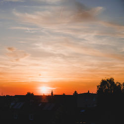 Silhouette buildings against sky during sunset