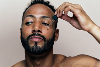 Close-up of young man against white background