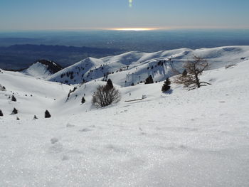 Scenic view of snow covered landscape against sky