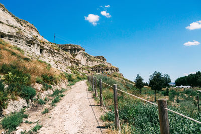 Scenic view of mountains against blue sky