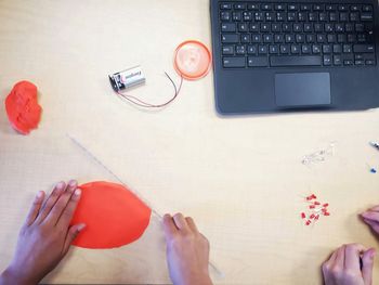 High angle view of person using laptop on table