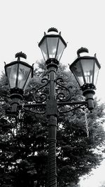 Low angle view of lamp post against sky