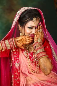 Midsection of woman wearing hat at temple