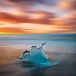 Close-up of sea against sky during sunset