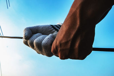 Low section of man against sky