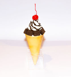 Close-up of drink served on table against white background