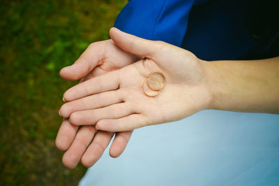 Close-up of couple holding hands