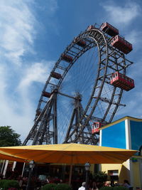 Low angle view of ferris wheel against sky