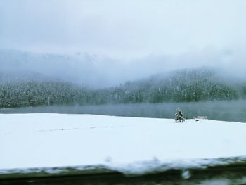 Scenic view of lake against sky during winter