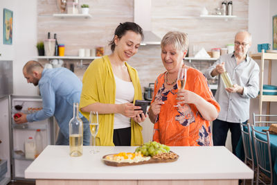 Portrait of young woman holding food at home