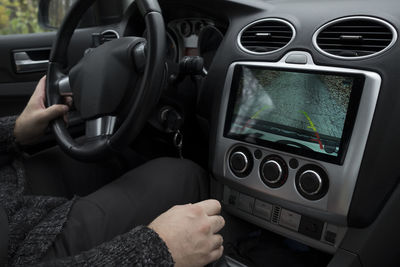 Close-up of man using smart phone in car