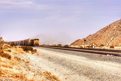 Train in desert against sky