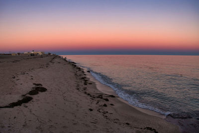 Scenic view of sea against clear sky during sunset