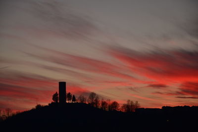 Silhouette trees against sky during sunset